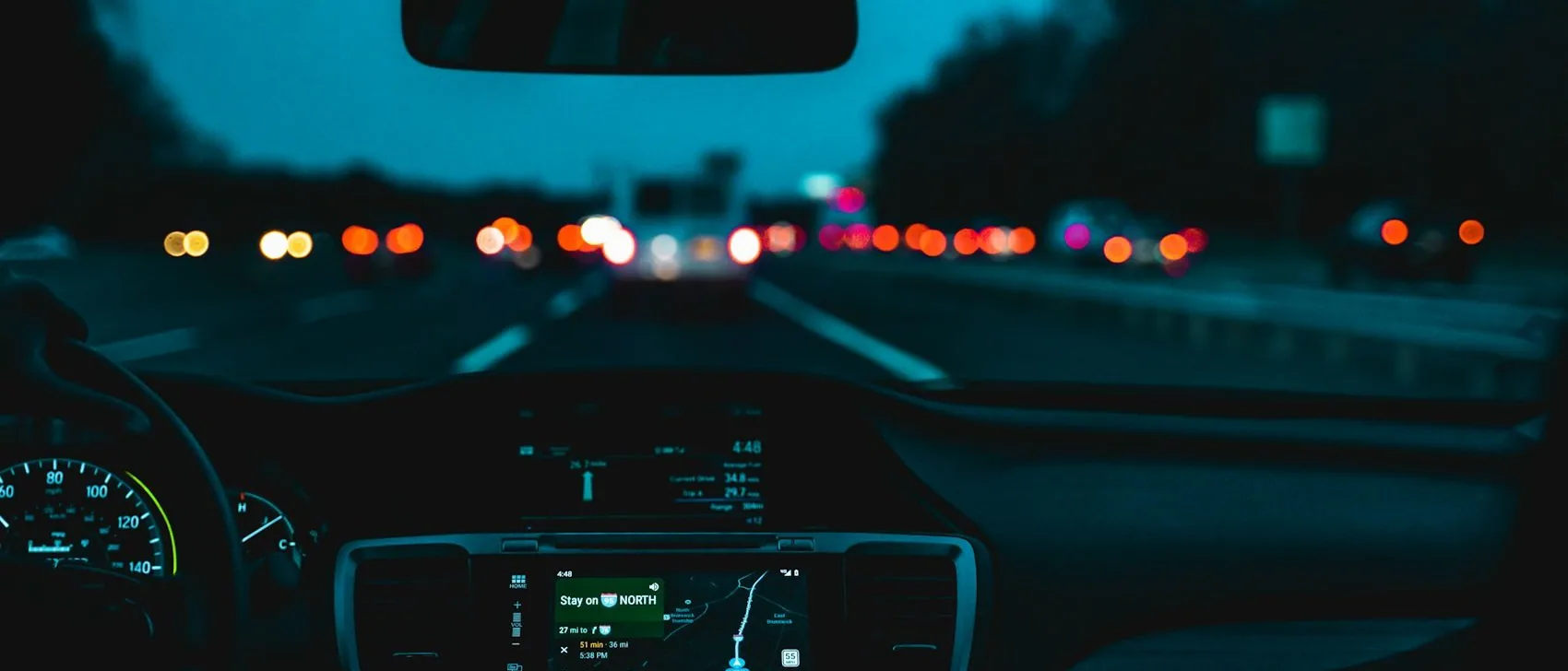 a dashboard at night on the motorway