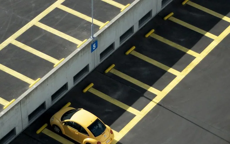 a car parking in a marked bay — article card
