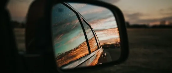 a door mirror at sunset