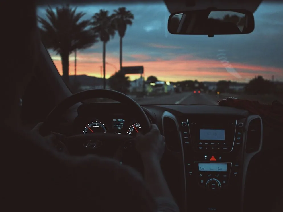 an instructor at work at sunset, from behind