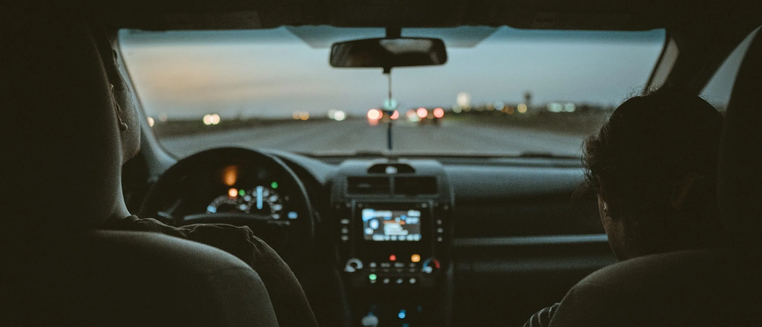 learner and instructor in the car, from behind, wide